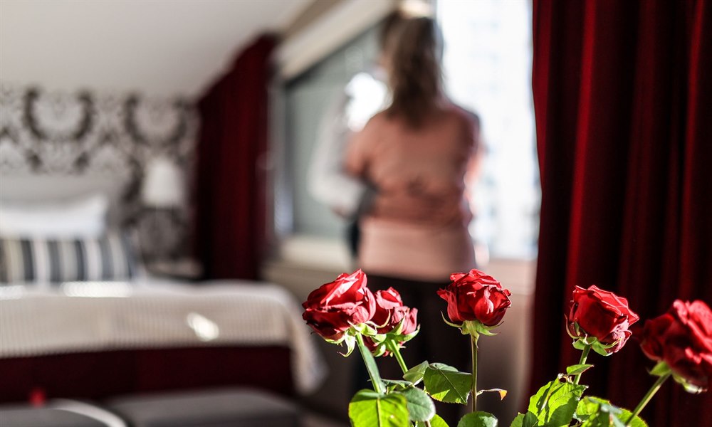 Some roses and two people in the background.