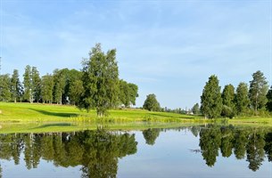 Nice golf course with small lake. Photo.