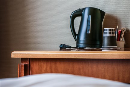 Electric kettle in standard double room. Image.