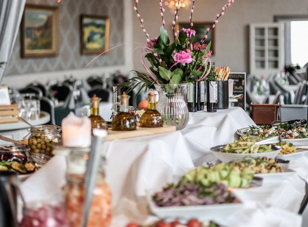 A buffet table with food.