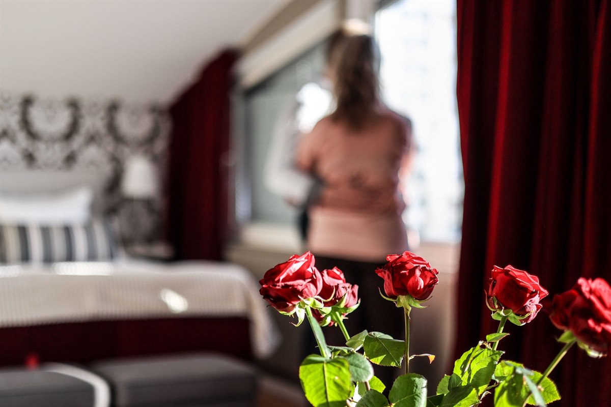 Some roses and two people in the background.