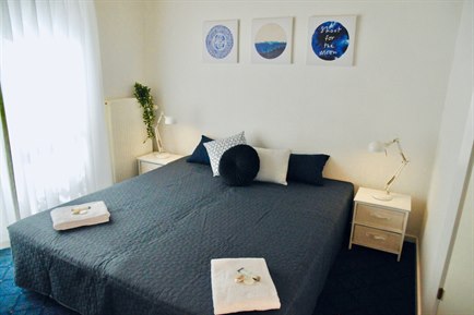 Nice Double Room with blue furniture. Photo.