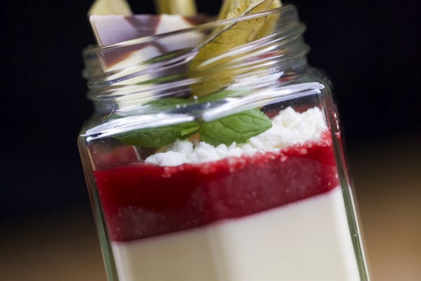 A glass jar with food. Image.