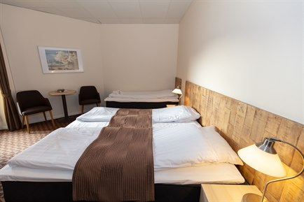 Large comfortable bed Triple rooms. Photo.