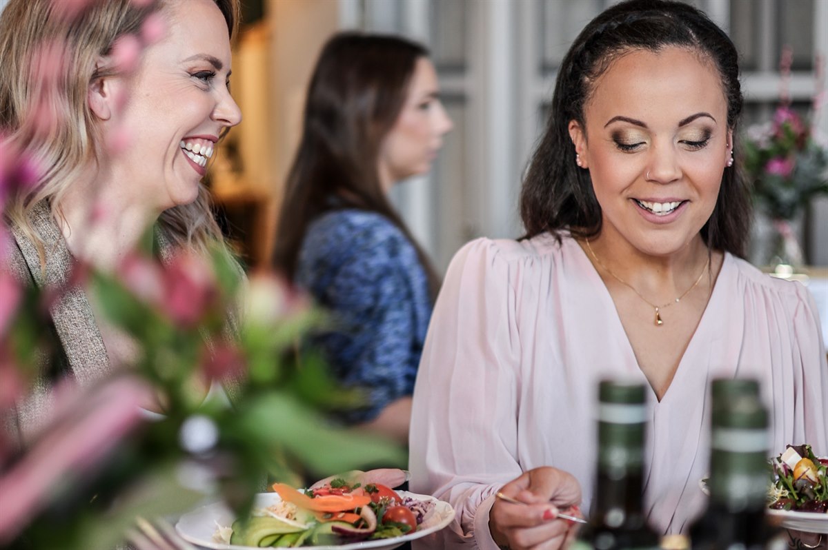 Two women in a restaurant interacting.