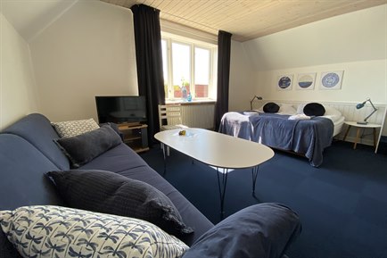 Nice Double Room with blue furniture. Photo.
