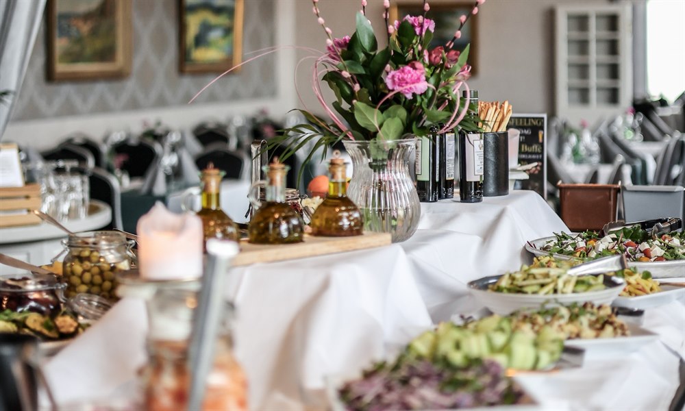 A buffet table with food.