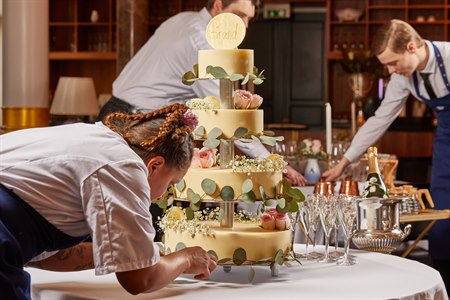 Decorating a wedding cake. Image.