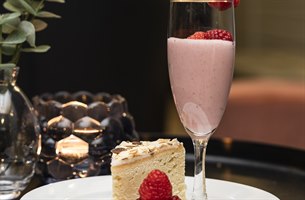 Cake and a glass of smoothie. Image.