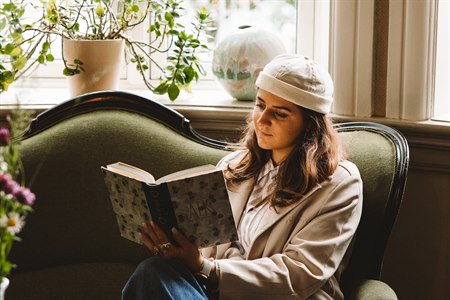 Woman reading in the lounge. Photo.