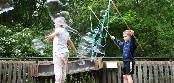 children playing with soap bubbles outdoors