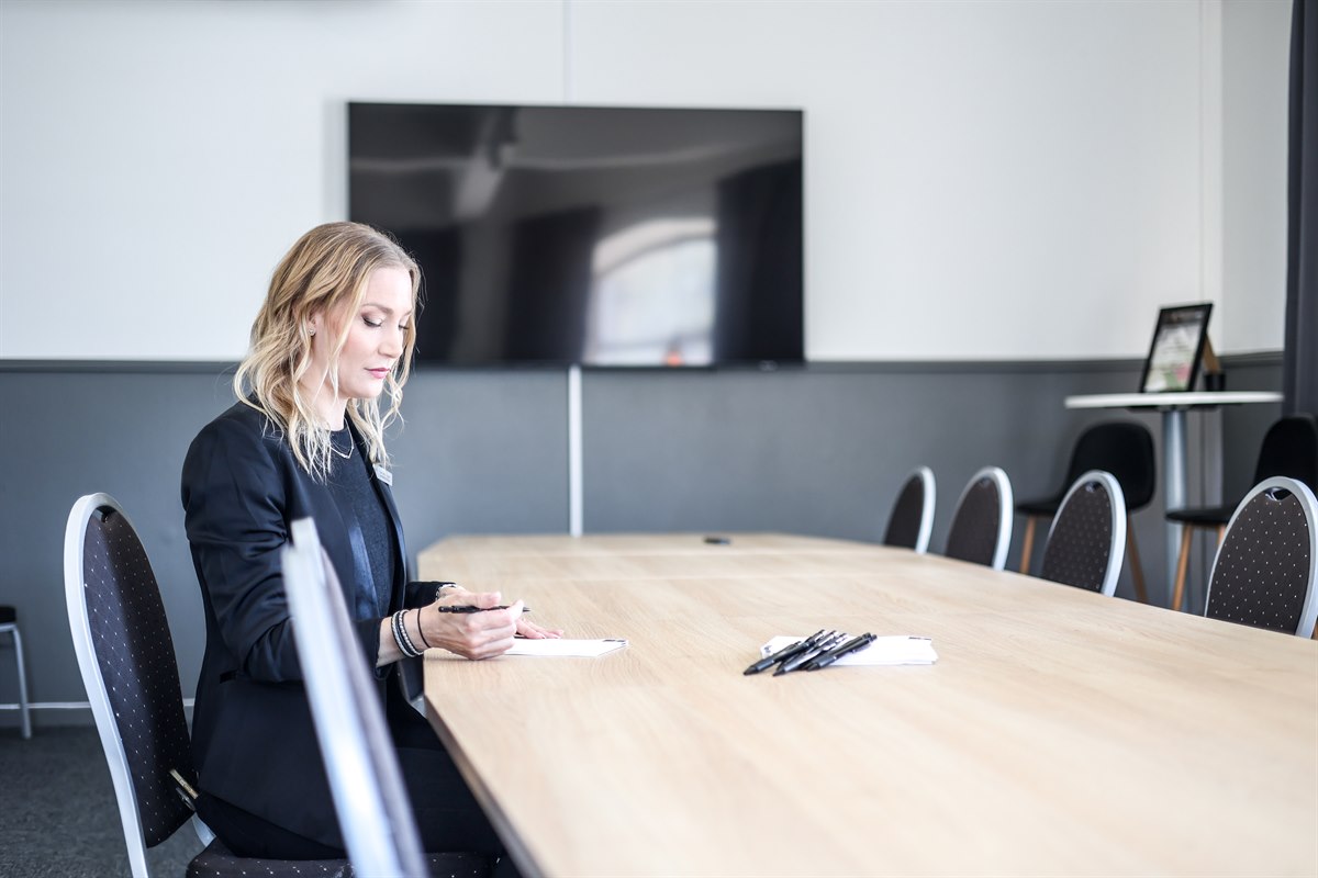 A woman in a meeting room.
