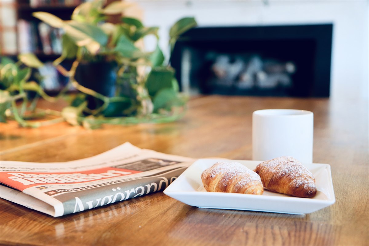 newspaper, coffee and buns