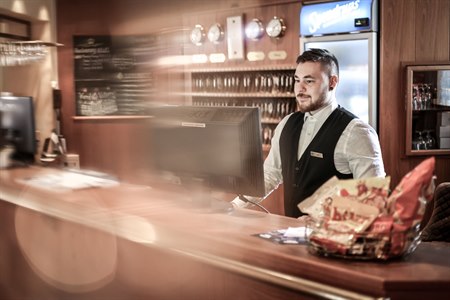 A male employee at the reception.