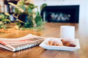 newspaper, coffee and buns