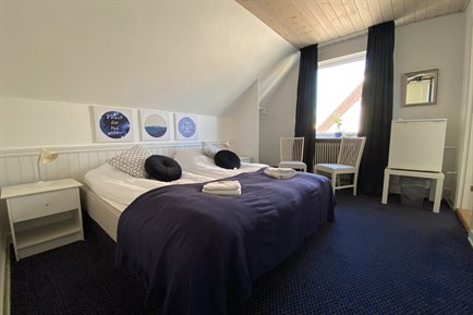 Nice Double Room with blue furniture. Photo.