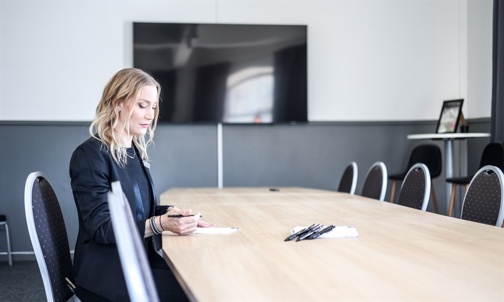 A woman in a meeting room.
