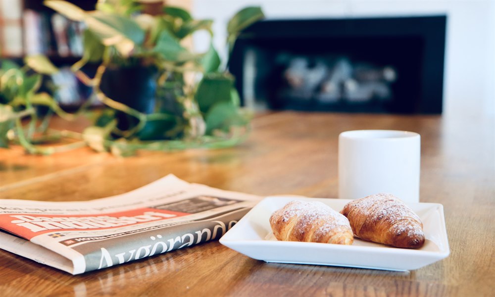 newspaper, coffee and buns