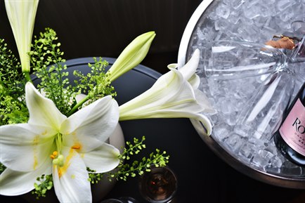 Close up on a flower and ice bucket. Image.