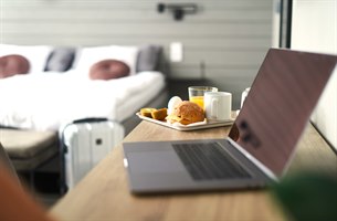 Frukost och en dator på ett skrivbord. Bild.