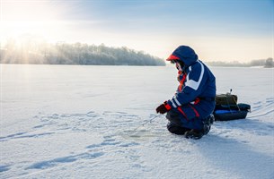 Ice fishing on a frozen lake. Photo.