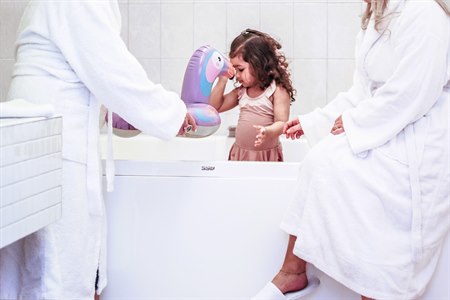 Two adults and a child in a jacuzzi.