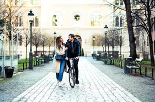 Two people on a stroll with a bike. Image.