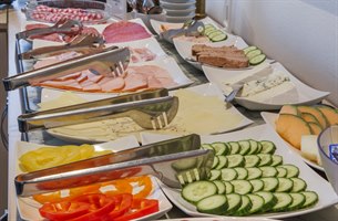 Delicious breakfast buffet with salami and vegetable. Photo.