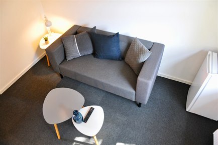 Sofa inside Deluxe Double Room. Photo.